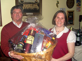 Dennis Dunleavey and Maeve Nevin with the Hamper raffled for the Croagh Patrick Challenge at Breaffy's Shamrock Bar. Click photo for more details.