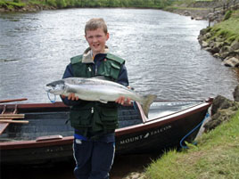 Twelve year old John Meade with his fist ever salmon caught on the famous Wall Pool at Mount Falcon. Click photo for more of the latest angling news.