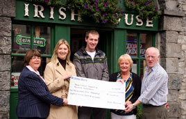 Eoin Heverin shorn of his dreadlocks presenting a cheque for over 10,000 to Mayo Cancer Support and Western Alzheimers. Click on photo for the details.