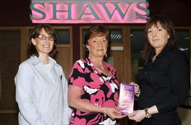 Ken Wright photographed Marian Monaghan winner of a prize bond voucher at Shaws. Click on photo for details.