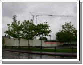 Behind the Hoarding brickwork is emerging from the foundations.