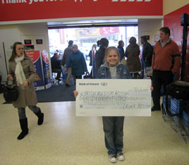 Laura Beston the youngest girl to complete the Seven Day In A Row Challenge of Croagh Patrick presents a cheque for over 1000 euro. Click photo for more details.