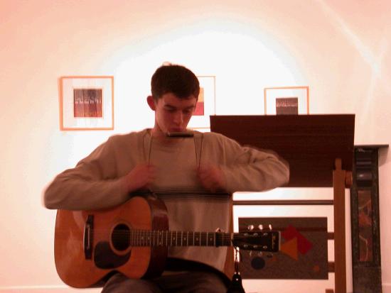 Daire O'Cuinn prepares to sing at the Launch of "Time to Write" by Linenhall Writers 2001-2004 Edited by JeanTuomey and Geraldine Mitchell. The book is a collection of prose and poetry written by writers who have worked with Jean Tuomey in creative writing groups. 26 Nov 2004.