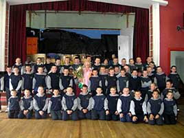 St. Patrick's 4th Class boys make a presentation to Peggy Lee. Click for details.