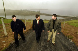 The Minister of State for the Gaeltacht and the Islands, Eamon O Cuiv, T.D., with Inishcuttle residents, Diarmuid and Patrick Quinn after he opened a new road there, yesterday (17 January 2001). Photo: Keith Heneghan / Phocus.
