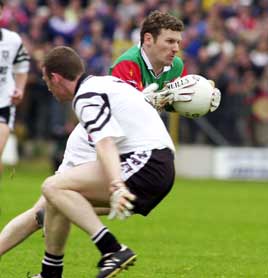 David Nestor of Mayo passes his Sligo opponent during the Connaught Championship match, Summer 2000. <br>Photo: Keith Heneghan / Phocus.