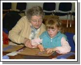 Breda Murphy presenting a visual arts workshop in Balla Community Centre, part of the Arts Office Bealtaine Celebrating Creativity in Older Age. Catherine Lyons helping her grandmother Rena Maloney . Photo  Ken Wright Photography 2007.