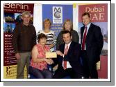 Balla 10k Road Race which was held on 28th July and raised 32,300 Euro which was divided between various charities.  Presentation of a cheque for 4,500 Euro to Huntingdons Disease Association Front L-R: Ann Hannon (Huntingdons Disease Association), Cyril Burke (sponsor Premier Estates Maloney). Back L-R: Joe Hannon 
Huntingdons Disease Association, Mary Brett (Road Race Committee), Patricia Conwell (Road Race Committee), Michael Maloney (sponsor Premier Estates Maloney). Photo  Ken Wright Photography 2007. 

