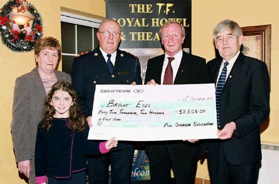 Garda presentation of a cheque to the Bright Eyes Fund for the breast cancer scanner for Mayo General Hospital. L-R: Nicole Devaney, Nora Devaney, and Chief Supt. John Carey
(Castlebar), Denis Gallagher (Chairman Bright Eyes Fund), Michael Devaney.
 Photo  Ken Wright Photography 2004. 
