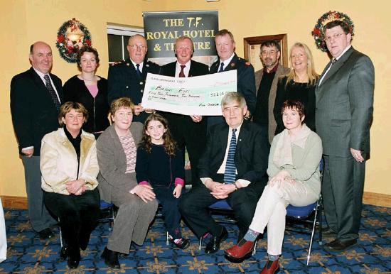 Garda presentation of a cheque to the Bright Eyes Fund for the breast cancer scanner for Mayo General Hospital. Organising Committee Front L-R: Marie Mellett, Nora Devaney,
Nicole, Michael Devaney, Helen Sarsfield, Back L-R: Brendan Coyne Marianne Jordan Chief Supt. John Carey (Castlebar), Denis Gallagher (Chairman Bright Eyes Fund), Asst. Commissioner Dermot Jennings (Galway) Frank Heraghty who produced the Show in the TF Royal Theatre, Mary & Pat Jennings Proprietors TF Royal Theatre & Hotel:  
Photo  Ken Wright Photography 2004. 
