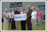 Presentation of a cheque for 8,000 to John Carey Mayo Cancer Support Association Rock Rose House Castlebar from De Care International the proceeds of the De Care Claremorris 10k Road Race, L-R: Angela Kirrane (Manager of Services Mayo Cancer Support Association),  Evelyn OConnor (De Care), Cathy Hughes (De Care), Maureen Walsh (MD De Care), Mairead Coughlan (De Care), John Carey (PRO  Mayo Cancer Support Association), Florence Devane (Mayo Cancer Support Association), Mairead Nestor (De Care) : Photo  KWP Studio 094