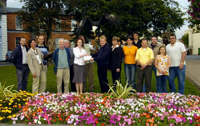 Pictured on the Mall at a presentation of a holiday voucher by Charlene Morrison PRO Feile Tir na nOg to Dr. Luke ODonnell winner of the first prize in the fundraising raffle. The raffle was part of the fundraising event held in Murrisk in order to raise funds for Mrs Quinns charity shop in Castlebar supporting the   National Council for the Blind. Michael Campbell (co-ordinator), and committee members,  Michael Joe Gavin, Damien Reilly, Brian Mongan, Cyril Scahill, Dan Stannard and Eileen Cassells (Manager Mrs Quinns Castlebar), Also in the picture Regina and Lothar Muschketat with Rory the owl and Alaska the bald eagle from Eagles Flying Irish Raptor Research Centre Ballymote Co.Sligo.  Photo  Ken Wright Photography 2007. 