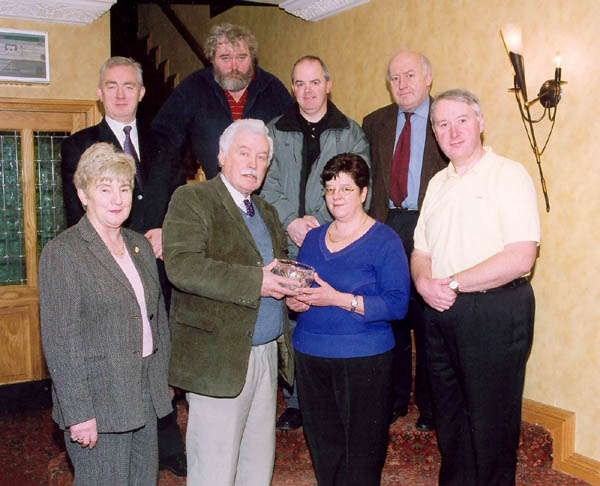 Pictured in the Welcome Inn  at presentation by the Irish Emigrant Liaison Committee (Mayo Branch) to Nado Cafolla in appreciation
of her contribution to the committee and also to mark her retirement from business are. Front L-R: Mary Doyle, Johnny Mee Chairman MELC, Nado Cafolla, James OMalley. Back L-R: Joe ODea, Mick Morgan, Blackie Gavin, Kevin Bourke. Photo  Ken Wright Photography 2004 

