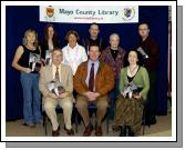 
Pictured in Castlebar Library at the launch of Booklet Celebrating 20 years of Mick Flavin Complied by Audrey Healy.Front L-R; Austin Vaughan County Librarian, Mick Flavin, Paula Leahy-McCarthy. Back L-R: Noreen Hoban, Audrey Healy, Anne Coyne, Pat Ryan, Mary Murphy, Alan King. Photo  Ken Wright Photography 2007. 

