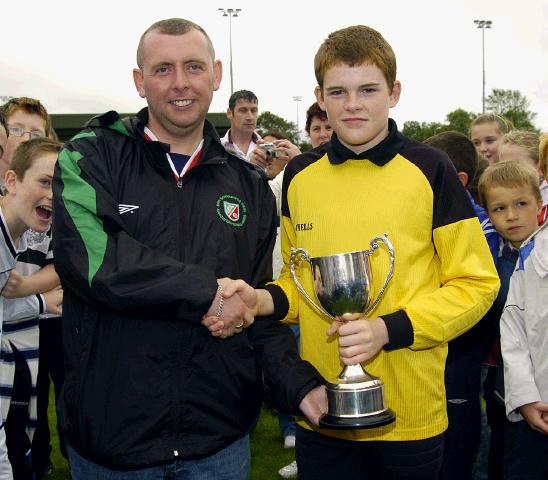 Ballina V Swinford  Kenneth Gannon fixtures secretary Mayo Schoolboys and Girls Youths presenting the under 14 league cup to Ballina team captain Brendan Murray. Photo Ken Wright 