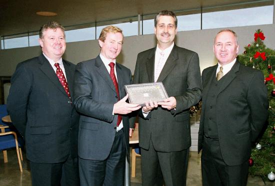 Enda Kenny TD & Leader of Fine Gael, presents Art  Silleabhin (ICT Advisor with Mayo Education Centre) with the Hibernia College Person of the Year 2004 Award, at a ceremony in Mayo Education Centre.
(L-R) Dr. Sen Rowland (Chairman of Hibernia College), Enda Kenny TD & Leader of Fine Gael, Art  Silleabhin (ICT Advisor with Mayo Education Centre) & Denis OBoyle (Director Mayo Education Centre). (Photography by Ken Wright)
