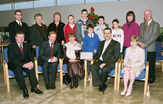 Enda Kenny TD & Leader of Fine Gael, presents Art  Silleabhin (ICT Advisor with Mayo Education Centre) with the Hibernia College Person of the Year 2004 Award, at a ceremony in Mayo Education Centre with the  Silleabhin family.
(Front L-R)  Dr. Sen Rowland (Chairman of Hibernia College), Enda Kenny TD & Leader of Fine Gael, Mire U Shilleabhin, Leas Promh Oide Scoil Raifteir, Art g  Silleabhin, Art  Silleabhin, Dr. Toni McManus (Head of Education Hibernia College) (Back L-R) Ronan OSullivan, Alice OSullivan, Dorrie Murphy, Cian  Silleabhin, Eoin  Silleabhin, Darach  Silleabhin, Fiachra  Silleabhin, Siobhan OConnor, Kevin Murphy. (Photography by Ken Wright)
