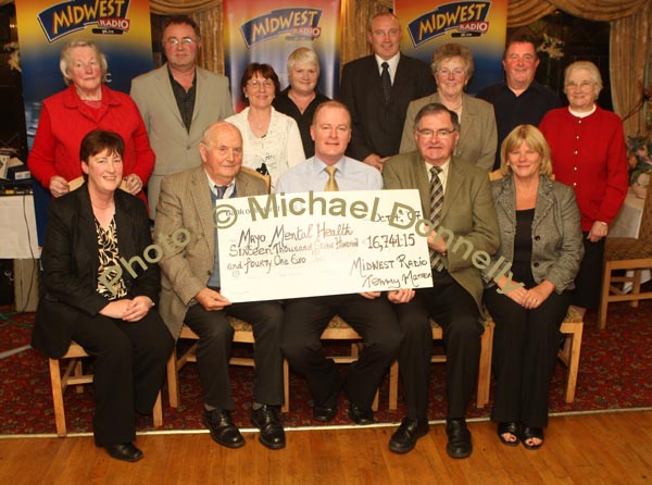 Tommy Marren of Mid West Radio present a cheque for 16,741 Euros and 15 cent from the Magnificent 7 Fundraising Challenge to Mayo Mental Health pictured front from left: Kathleen McHale, secretary, Mickey Berry; Tommy Marren Mid west Radio; PJ Murphy, Chairman Mayo Mental Health, and Dr Fidelma Creaven; At back from left: Kathleen Brawn, Michael Larkin, Mary Murphy, Maura Berry, Cllr Eugene McCormack, Mayor of Castlebar; Nellie Egan, Tony O'Boyle and Sr. Ita Hoban. Photo:  Michael Donnelly