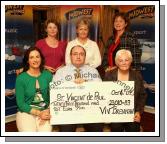 Viv Brennan of Mid West Radio presents a cheque fo 23,010 Euros and 83 cent from the Magnificent 7 Fundraising Challenge to St Vincent de Paul, front from left: Carmel Bolster, Viv Brennan and Kay Veale; at back: Una Jordan, Joan Redmond, and Anne Leonard. Photo:  Michael Donnelly