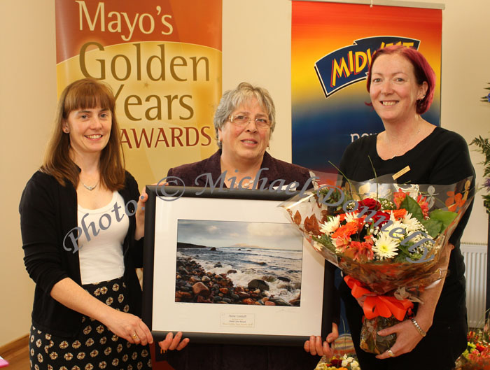 Eileen McNamara Mayo Carers Association  presents the "Good Carer Award" to Ann Corduff, Barhauve, Rossport, Ballina, at the Mayo's Golden Years Awards at Homecare Medical Supplies Ballyhaunis in association with Mid West Radio.  Sarah Burke, Homecare Medical Supplies  presents the Bouquet. Photo:Michael Donnelly