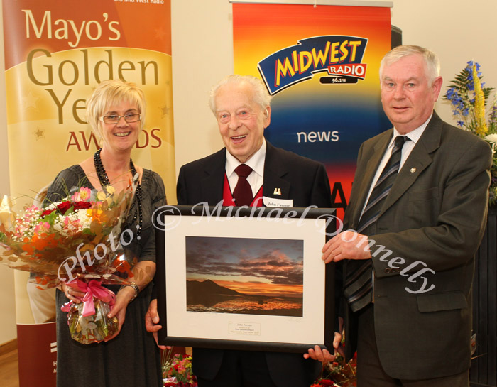 John Farmer, Kilmaine Rd, Ballinrobe, Co. Mayo (centre) is presented with the  Good Volunteer award, at the Mayo's Golden Years Awards at Homecare Medical Supplies Ballyhaunis in association with Mid West Radio by Marie Munnelly, Mayo Volunteer Centre included in photo is Michael Rattigan, Knock,  who nominated John.Photo:Michael Donnelly,

 