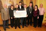 John OShaughnessy, chairman of the Mayo People in Need Committee, (centre) presents a cheque for 9,000 Euros to John Grant, CEO Western Alzheimers Foundation, at the distribution of funds of the "Telethon 2004 - People in Need" fundraising, in the Welcome Inn Hotel Castlebar, include in photo are People in Need Committee, from left: Tom Kenny, Betty Dabbagh, Fundraising  co-ordinator; John OShaughnessy, James Kilbane, John Grant, Pat Murray, President Castlebar Chamber of Commerce; Helen Kenny and Michael Rooney committee.  Photo Michael Donnelly