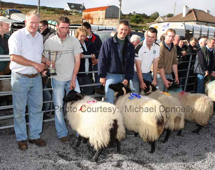 Sean Graven presents The Graven Family Cup for the Ewe Lamb (confined) class to Martin Calvey, Dookinella at the 21st Achill Sheep Show (Taispentas Caorach Acla 2007)  at Pattens Bar, Derreens Achill; 2nd prize was won by  Sean Gallagher, Currane; 3rd  Stephen O'Malley, Currane and 4th to Pat Vesey The Valley.  .Photo:  Michael Donnelly