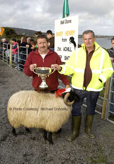 John Nolan, Newport is presented with the John Patten Cup by Irvin Moran (Achill Sheep Show Committee) for Best Ram Lamb (Open) class at the 21st Achill Sheep Show (Taispentas Caorach Acla 2007) at Pattens Bar, Derreens Achill. Photo:  Michael Donnelly