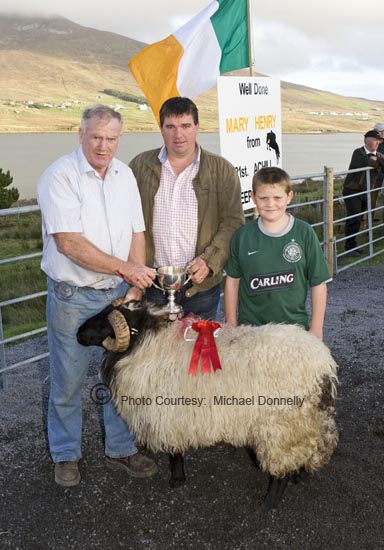 Sean Graven, Currane Achill, winner of the Hogget Ram (Open) class at the 21st Achill Sheep Show (Taispentas Caorach Acla 2007) at Pattens Bar Derreens Achill is presented with the Mary Ellen Grealis Memorial Cup by Noel Grealis, included in photo is Seamus Tiernan. Photo:  Michael Donnelly