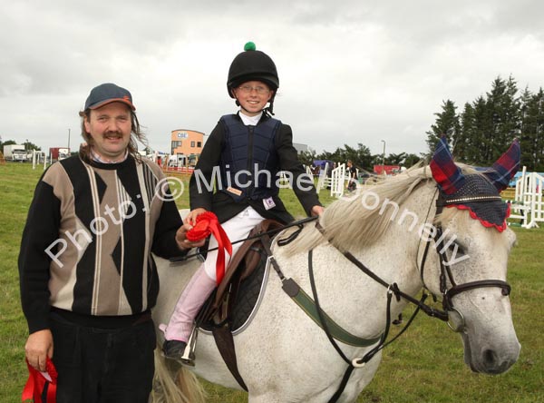 Noel Coleman (Judge) presents  a shared 1st prize in the 138 C and D at Claremorris Agricultural Show to Emily Nielson Athenry (on Smurf). Photo:  Michael Donnelly