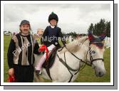 Noel Coleman (Judge) presents  a shared 1st prize in the 138 C and D at Claremorris Agricultural Show to Emily Nielson Athenry (on Smurf). Photo:  Michael Donnelly