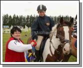 Anne Erdok (Judge) presents 1st prize in the 128 ABC at Claremorris Showjumping section of Claremorris Agricultural Show to Jason Sweeney, Ballina, grandson of Joe Sweeney, Ballina. Photo:  Michael Donnelly