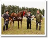 Liam and Michael Lynskey, Swinford are presented with the James Prendergast Memorial Cup by Pat Prendergast (sponsor) at Claremorris Agricultural Show for "Lady in Red" winner of  James Prendergast Memorial Cup class- Best Brood mare to breed a hunter with or without foal at foot. Photo: Michael Donnelly.