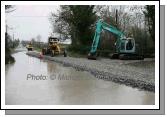 Mayo Co Co workmen raise the road level at Ballytrasna just outside Ballinrobe on the Kilmaine Road. Photo:  Michael Donnelly