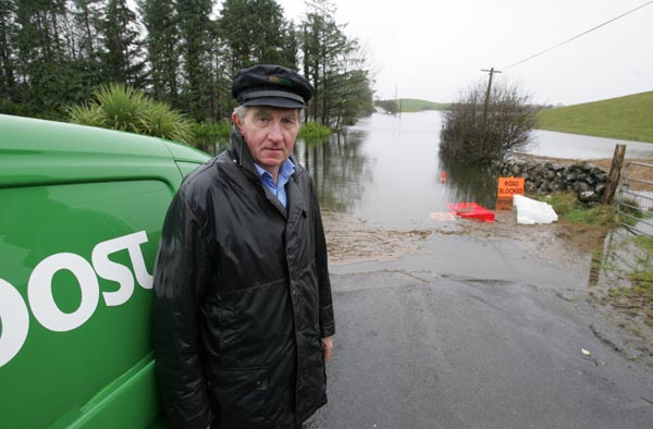 Floods Stopping Postman Sean Joyce at Ballinacarra, Kilmaine from accessing his neighbours, and some of the local farmers are forced to make a 15 mile mile trip to feed thier animals. Photo:  Michael Donnelly