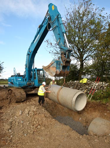 Gerard McGough and Mick Butler guide one of the last few 3ft Daimeter by 8ft long pipes into position to relieve the winter flooding from the Thomastown Turlough Kilmaine. Photo:  Michael Donnelly