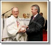 Gerry Concannon, CEO and Chairman of CBE makes a presentation to his uncle Monsignor Cathal Brennan, (who travelled 6,000 miles from Portland Oregan USA) at the official opening of CBE's new Head Office and Research and Development Centre in the IDA Business Park, Claremorris. Photo:  Michael Donnelly