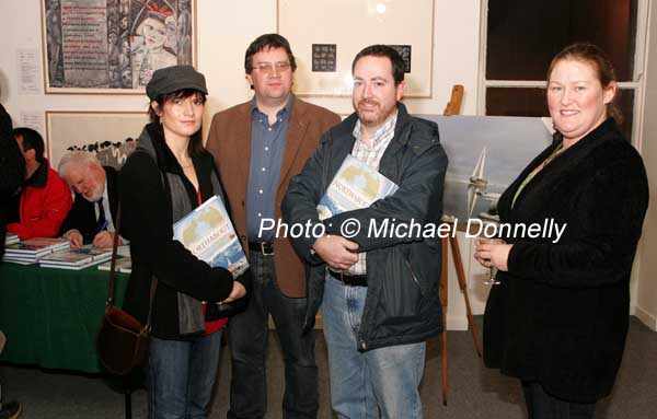 Pictured at the "Northabout" book launch in the Linenhall Arts Centre by Northabout skipper Jarlath Cunnane as he signs his book "Northabout" (sailing the North East and North West Passages) from left: Ursula McShane, Brendan Minish, Paul Cunnane and Annie Minish. In background is a photo from the the expedition. Photo:  Michael Donnelly