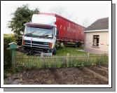 The truck crashed through a wall in Ballyheane and ended up in a fishpond after the driver took ill. It narrowly missed the house.