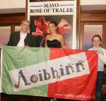 Michael and Tara Baynes  from the Tweed Centre, Main St Castlebar present a flag to  Mayo Rose Aoibhinn N Shilleabhin. Photo: Michael Donnelly.