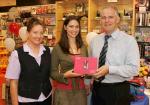 Pat Staunton presents a Canon IXUS i5 digital camera to Mayo Rose of Tralee Aoibhinn N Shilleabhin, a former member of staff of Stauntons Photo Shop. Included in photo is Mary Moran manageress  Stauntons Digital One Hour Photo. Photo: Michael Donnelly.