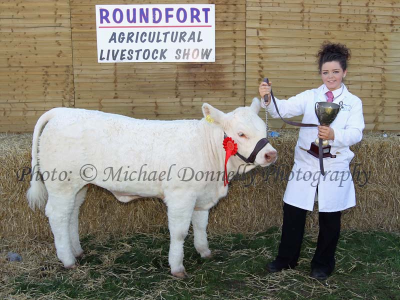 Emma Higgins, Ballindine, Co Mayo  pictured with the Kathleen Nally Memorial Perpetual Cup  at Roundfort Agricultural Show after winning the Roundfort Young Stockperson Championship. Photo: © Michael Donnelly Photography