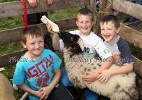  Pet Lambs need a drink too on a hot day at Roundfort Agricultural Show, pictured from left: Stephen Ferriter, Roundfort, Morgan Pilbrow and  Daniel Ferriter Photo: © Michael Donnelly Photography