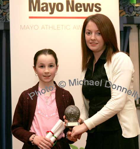 Juvenile Female Cross Country winner, Aoife Mulroy,  of Swinford AC accepts her award from  Sinead O'Malley of The Mayo News. Photo:  Michael Donnelly