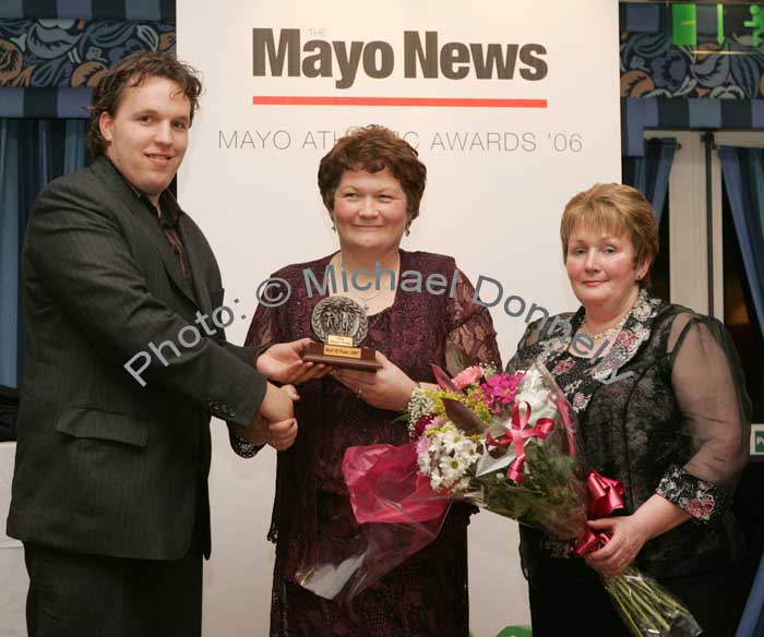 Edwin McGreal of the Mayo News presents the Hall of Fame award to Sheila Mangan Belmullet at the Mayo News Mayo Athletic Awards, in Hotel Westport while Marian Mattimoe, PRO Mayo Athletic Board presents her with a Bouquet of flowers. Photo:  Michael Donnelly