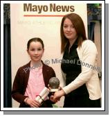 Juvenile Female Cross Country winner, Aoife Mulroy,  of Swinford AC accepts her award from  Sinead O'Malley of The Mayo News. Photo:  Michael Donnelly