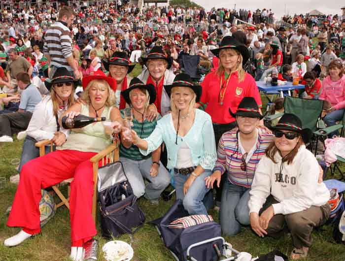 Mary Maguire, Claremorris pours the champagne with friends from Mayo, Galway, Leitrim and Donegal  after Mayo defeated Laois game on the Big Screen at the  "Craic on the Track" at Ballinrobe Racecourse. All live and work in Claremorris.  Photo: Michael Donnelly.