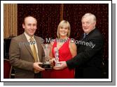 Donal O'Gallachoir chairman Breaffy GAA Club (on right) presents the Breaffy GAA Clubman of the year award to Sean Grealis at the Breaffy GAA Annual Dinner Dance in Breaffy House Hotel, Castlebar. Included in photo is Mary Grealis. Photo:  Michael Donnelly