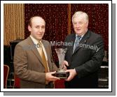 Sean Grealis is  presented with the Margaret Canny Memorial Trophy for Breaffy GAA Clubman of the Year by Donal O'Gallachoir Club chairman at the Breaffy GAA Annual Dinner Dance in Breaffy House Hotel, Castlebar. Photo:  Michael Donnelly