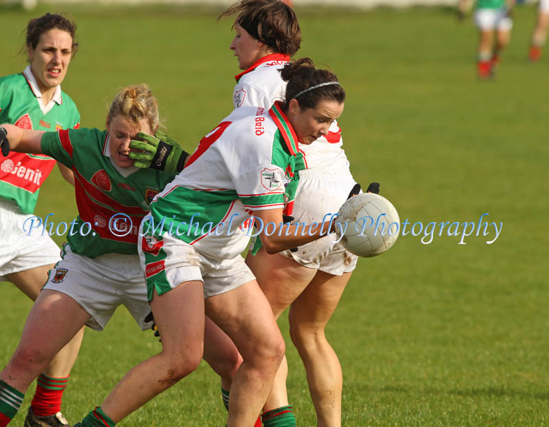 Michelle Walsh  of St Bridgids Kiltoom, gets by as her team mate Fiona Gavin blocks the vision of Carnacon captain Fiona McHale in the Tesco Connacht Ladies Gaelic Football  Senior Club Championship final in Canon Gibbons Park Claremorris. Photo: © Michael Donnelly Photography